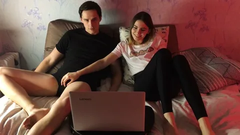 Bored of movie, she grabs his cock under laptop 😏